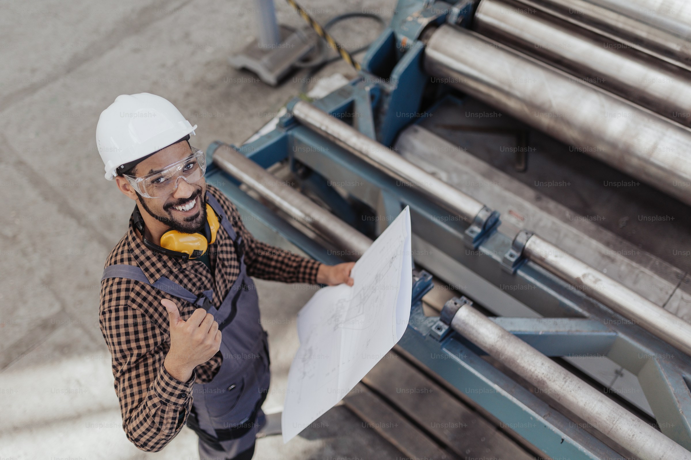 Engineer reviewing facility blueprints